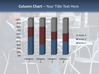 A Man In A Suit Sitting At A Table With A Laptop PowerPoint Template