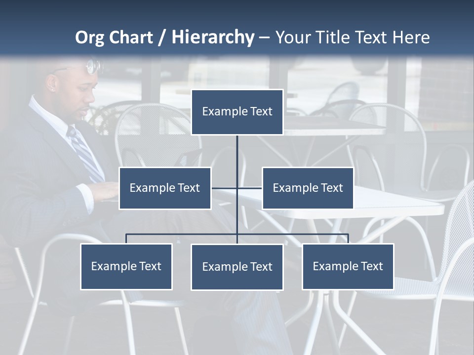 A Man In A Suit Sitting At A Table With A Laptop PowerPoint Template