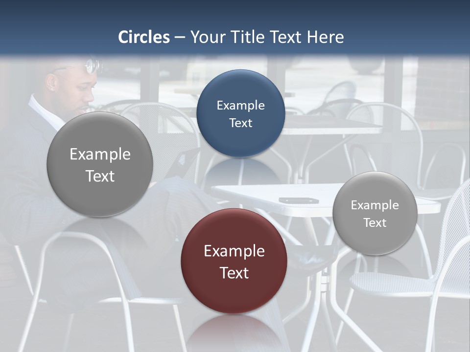 A Man In A Suit Sitting At A Table With A Laptop PowerPoint Template