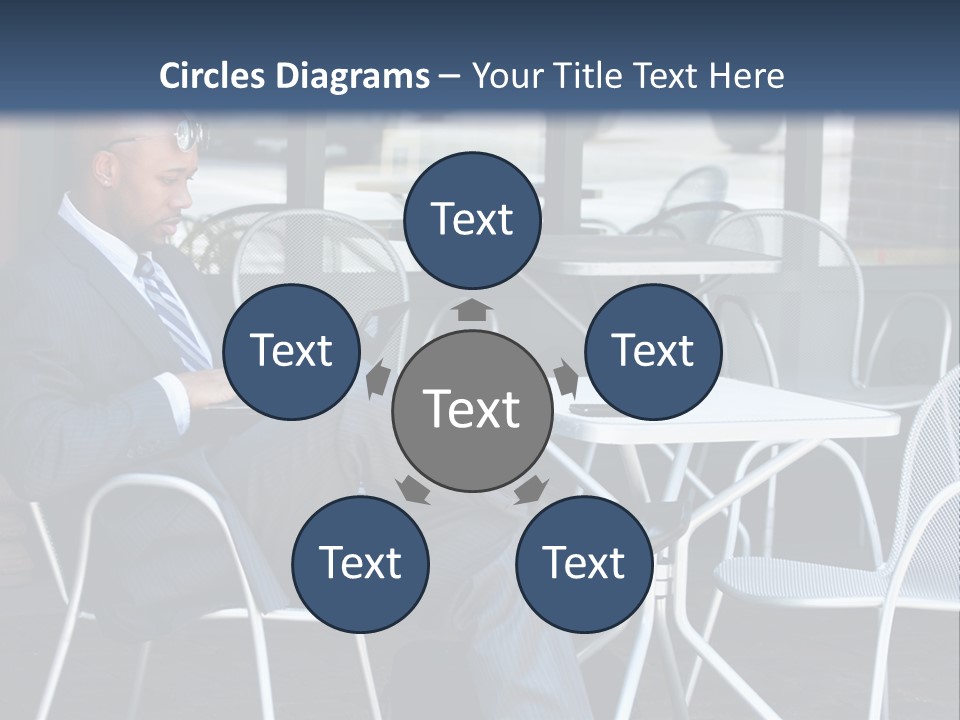 A Man In A Suit Sitting At A Table With A Laptop PowerPoint Template