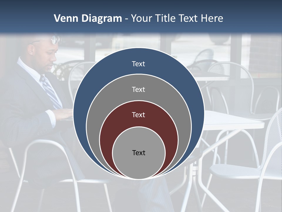 A Man In A Suit Sitting At A Table With A Laptop PowerPoint Template