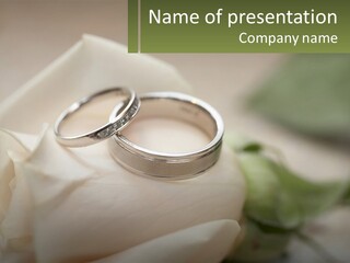 Two Wedding Rings Sitting On Top Of A White Rose PowerPoint Template