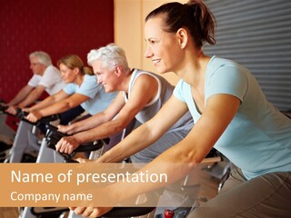 A Group Of People Riding Stationary Bikes In A Gym PowerPoint Template