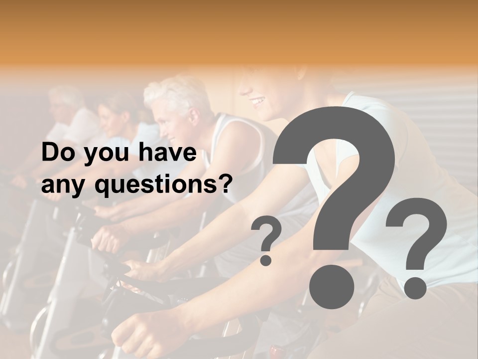 A Group Of People Riding Stationary Bikes In A Gym PowerPoint Template