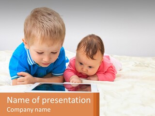 Two Children Laying On A Bed Playing With A Tablet PowerPoint Template