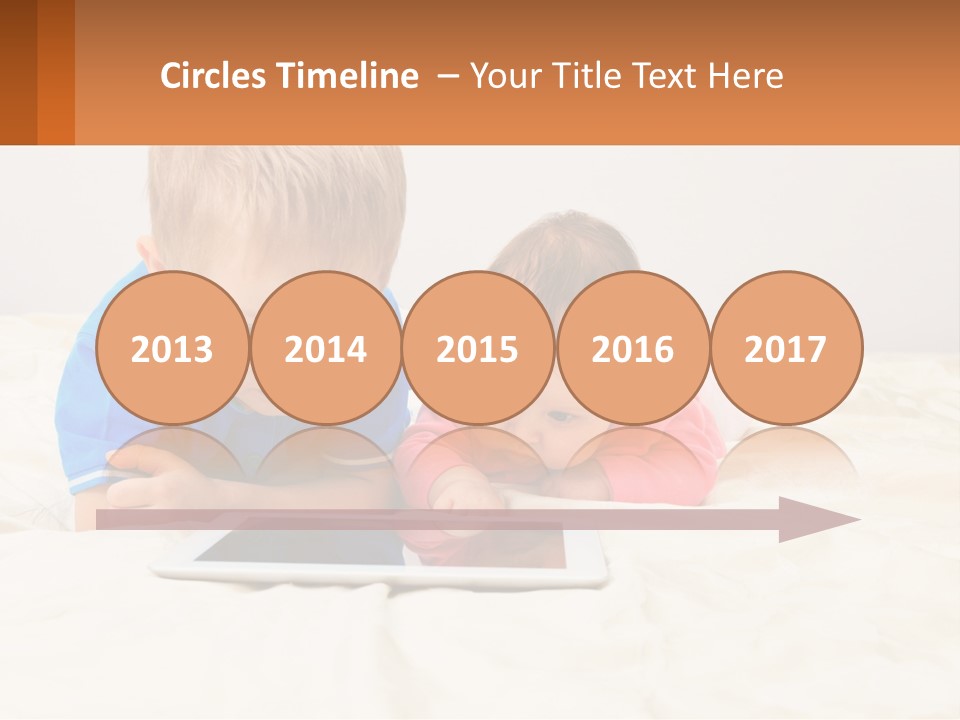 Two Children Laying On A Bed Playing With A Tablet PowerPoint Template