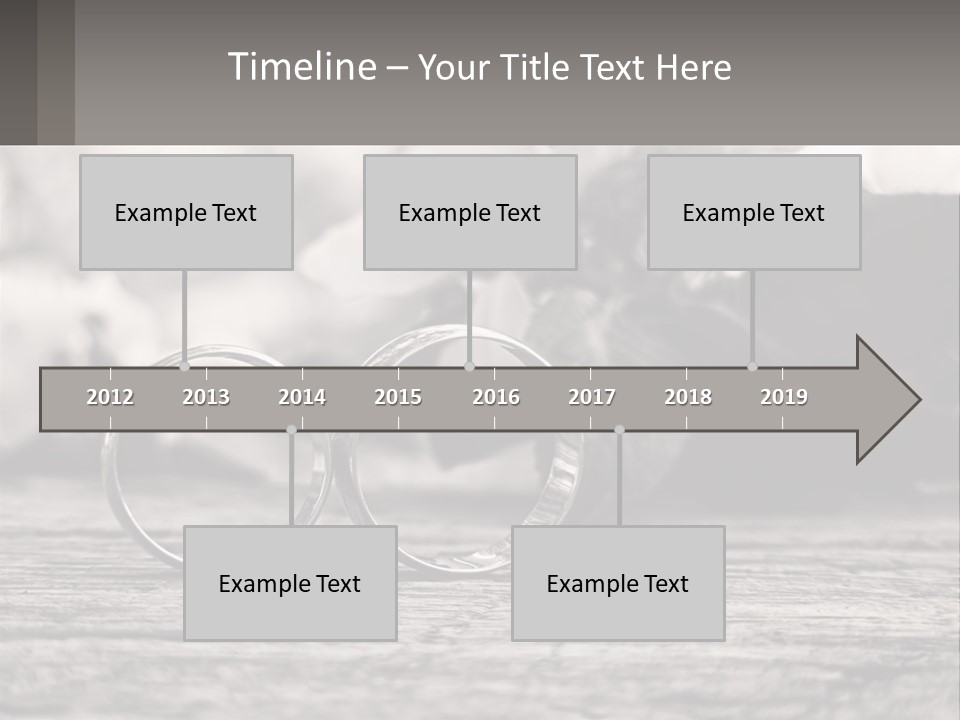 Two Wedding Rings Sitting On Top Of A Wooden Table PowerPoint Template