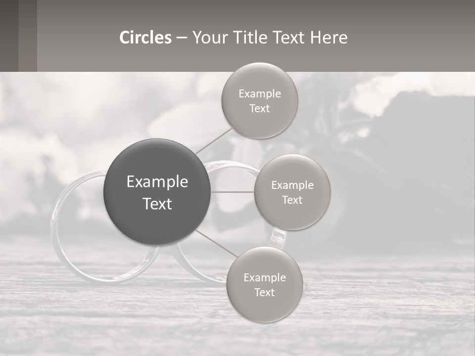 Two Wedding Rings Sitting On Top Of A Wooden Table PowerPoint Template