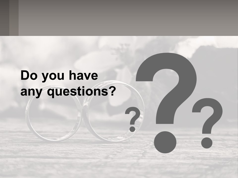 Two Wedding Rings Sitting On Top Of A Wooden Table PowerPoint Template