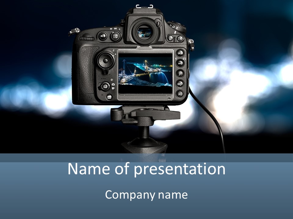 A Video Camera On A Tripod With Blurry Lights In The Background PowerPoint Template