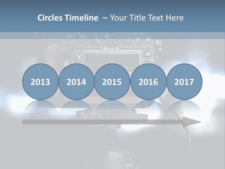 A Video Camera On A Tripod With Blurry Lights In The Background PowerPoint Template