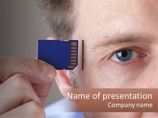 A Man Holding Up A Chip To His Eye PowerPoint Template