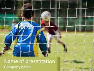 A Young Boy Kicking A Soccer Ball Towards A Goal PowerPoint Template