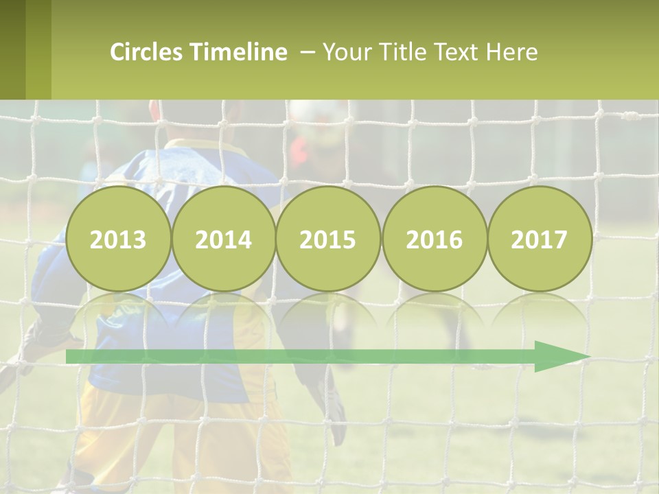 A Young Boy Kicking A Soccer Ball Towards A Goal PowerPoint Template