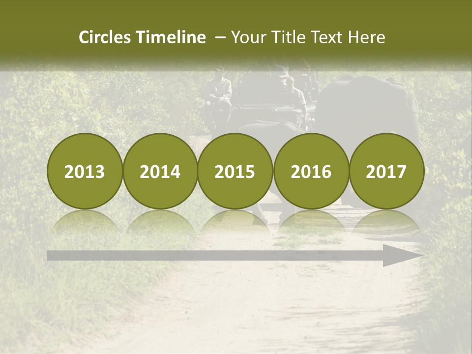 A Group Of Elephants Walking Down A Dirt Road PowerPoint Template