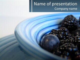 A Blue Bowl Filled With Blackberries On Top Of A Table PowerPoint Template