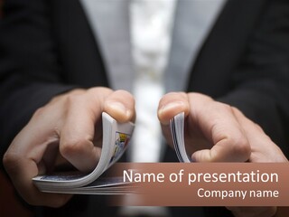 A Person Holding A Piece Of Paper In Their Hands PowerPoint Template