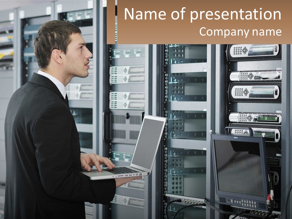 A Man Standing In Front Of A Server Holding A Laptop PowerPoint Template