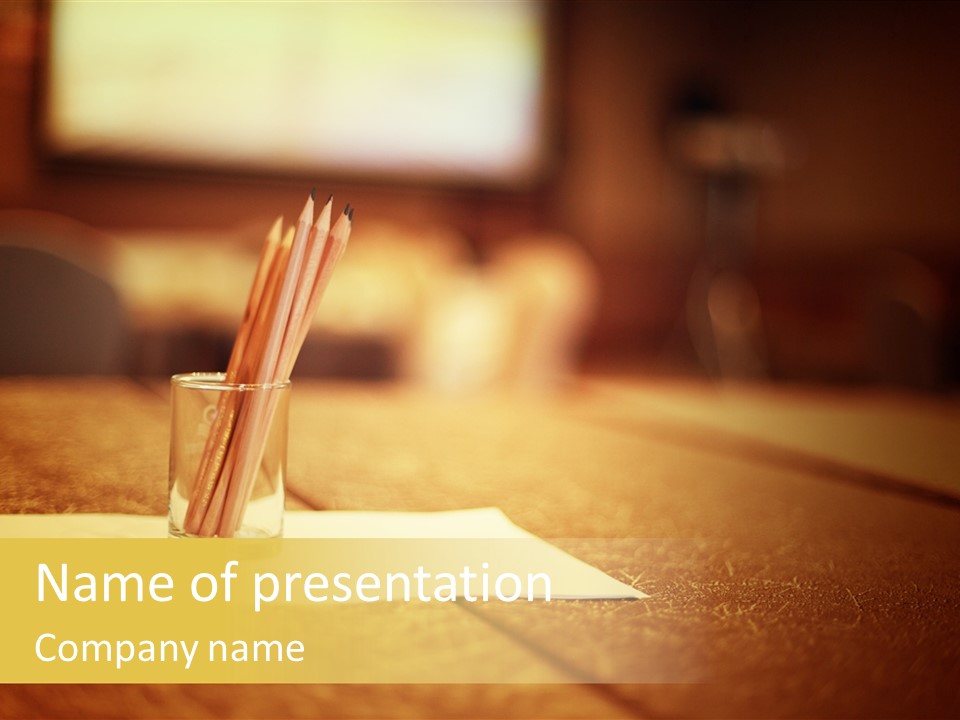 A Table With A Glass And Two Pencils In It PowerPoint Template