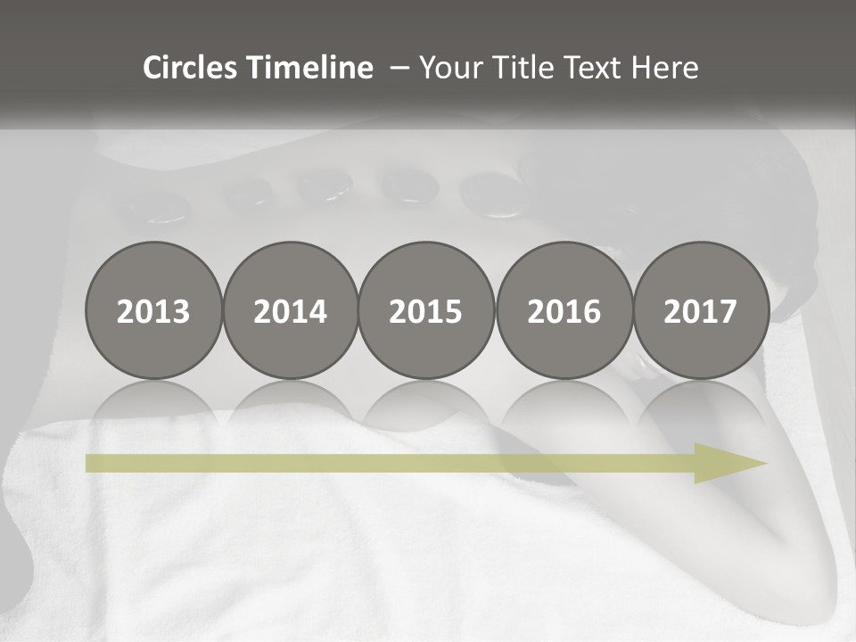 A Woman Laying On Top Of A Towel Covered In Stones PowerPoint Template