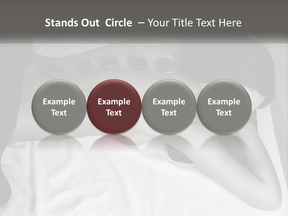 A Woman Laying On Top Of A Towel Covered In Stones PowerPoint Template