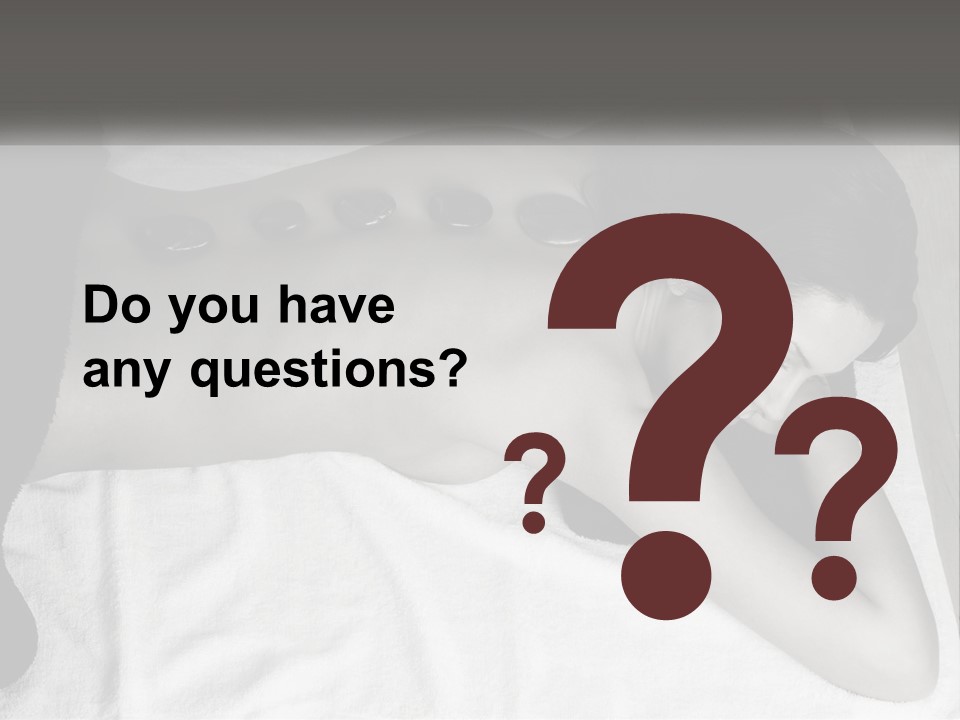 A Woman Laying On Top Of A Towel Covered In Stones PowerPoint Template