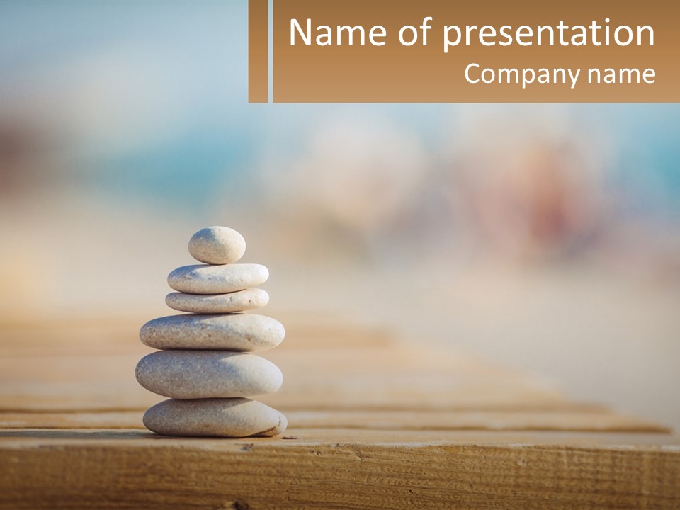 A Stack Of Rocks Sitting On Top Of A Wooden Table PowerPoint Template