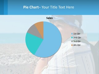 A Woman Sitting On The Beach Wearing A Blue Hat PowerPoint Template