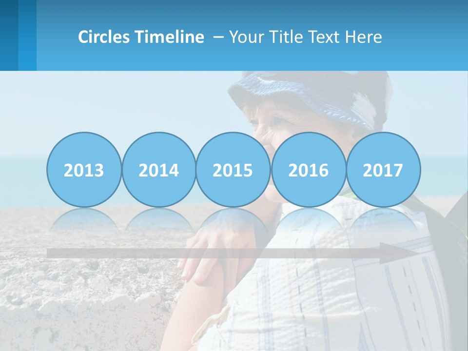 A Woman Sitting On The Beach Wearing A Blue Hat PowerPoint Template