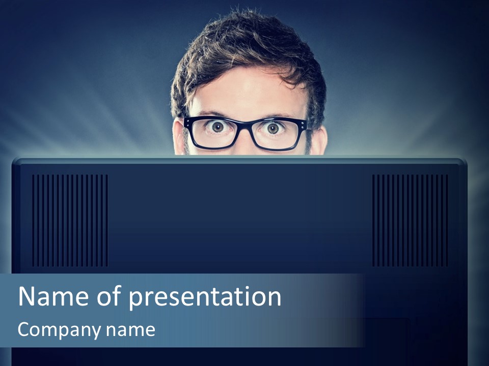 A Man With Glasses Is Looking At A Computer Screen PowerPoint Template