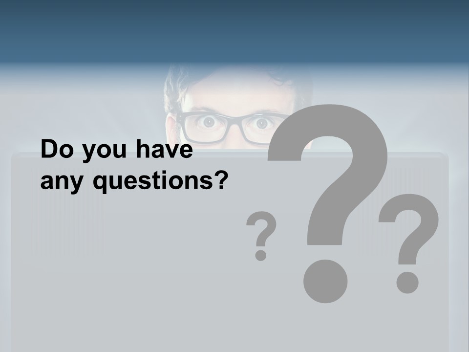 A Man With Glasses Is Looking At A Computer Screen PowerPoint Template