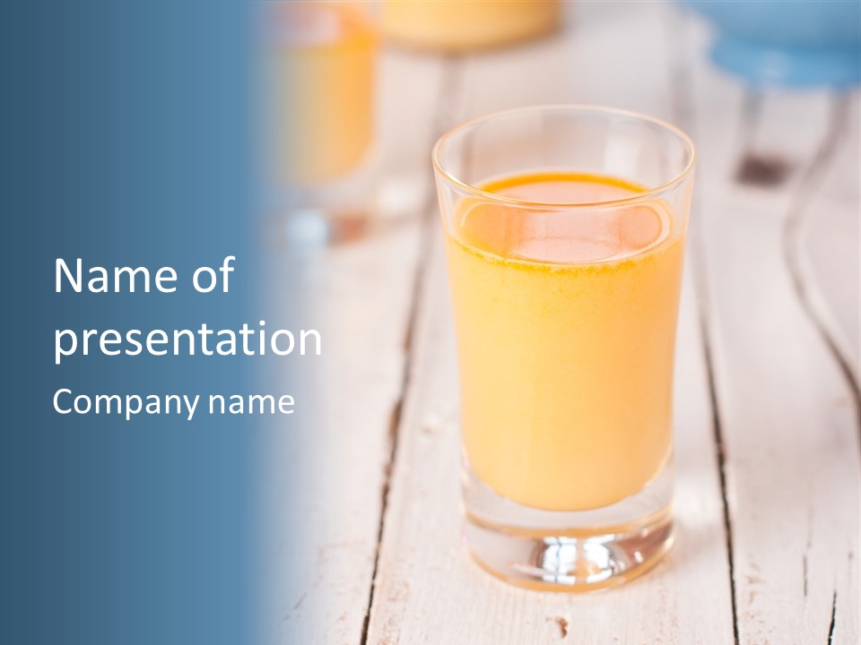 A Glass Of Orange Juice On A Wooden Table PowerPoint Template