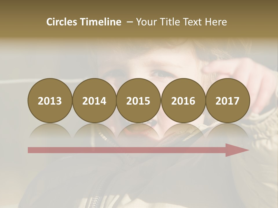 A Young Boy Is Smiling And Pointing At The Camera PowerPoint Template