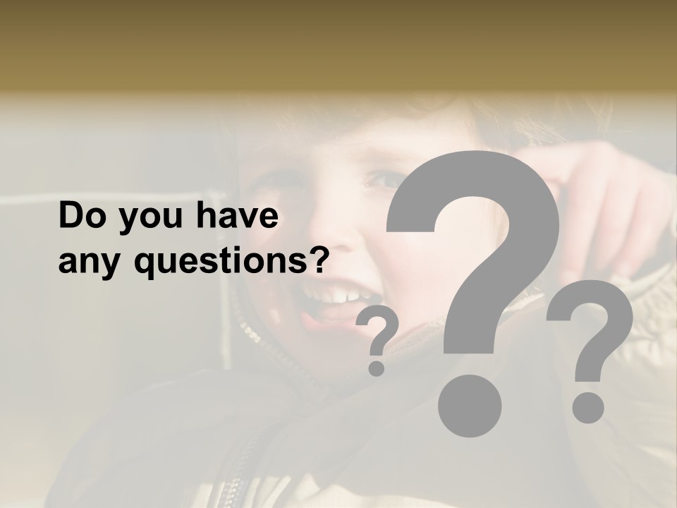 A Young Boy Is Smiling And Pointing At The Camera PowerPoint Template