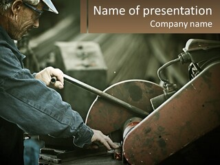 A Man Working On A Piece Of Machinery PowerPoint Template