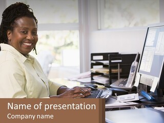 A Woman Sitting At A Desk With A Computer PowerPoint Template