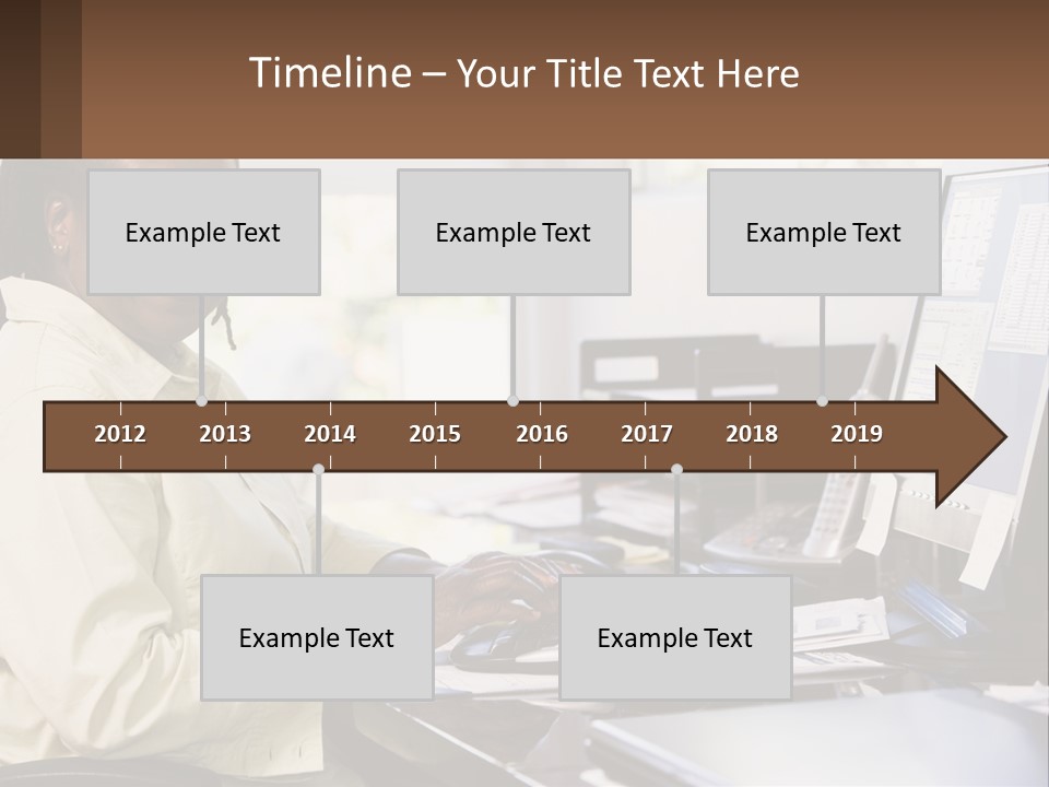 A Woman Sitting At A Desk With A Computer PowerPoint Template