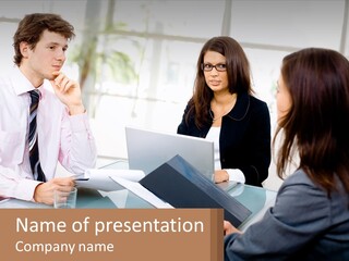 A Group Of People Sitting Around A Table With Laptops PowerPoint Template
