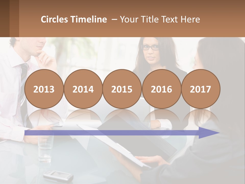 A Group Of People Sitting Around A Table With Laptops PowerPoint Template