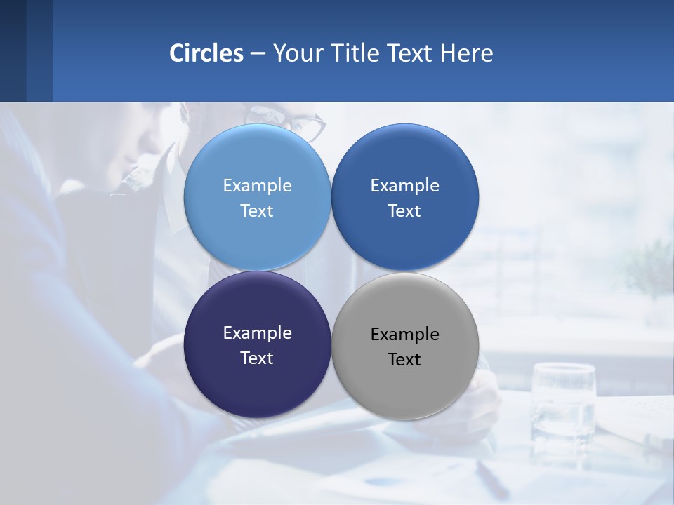 Two Men In Business Suits Sitting At A Table Looking At A Cell Phone PowerPoint Template