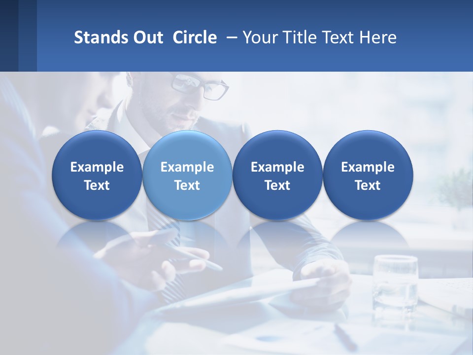 Two Men In Business Suits Sitting At A Table Looking At A Cell Phone PowerPoint Template