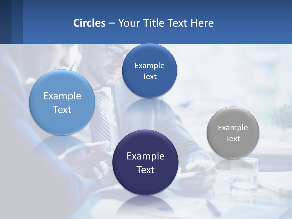 Two Men In Business Suits Sitting At A Table Looking At A Cell Phone PowerPoint Template
