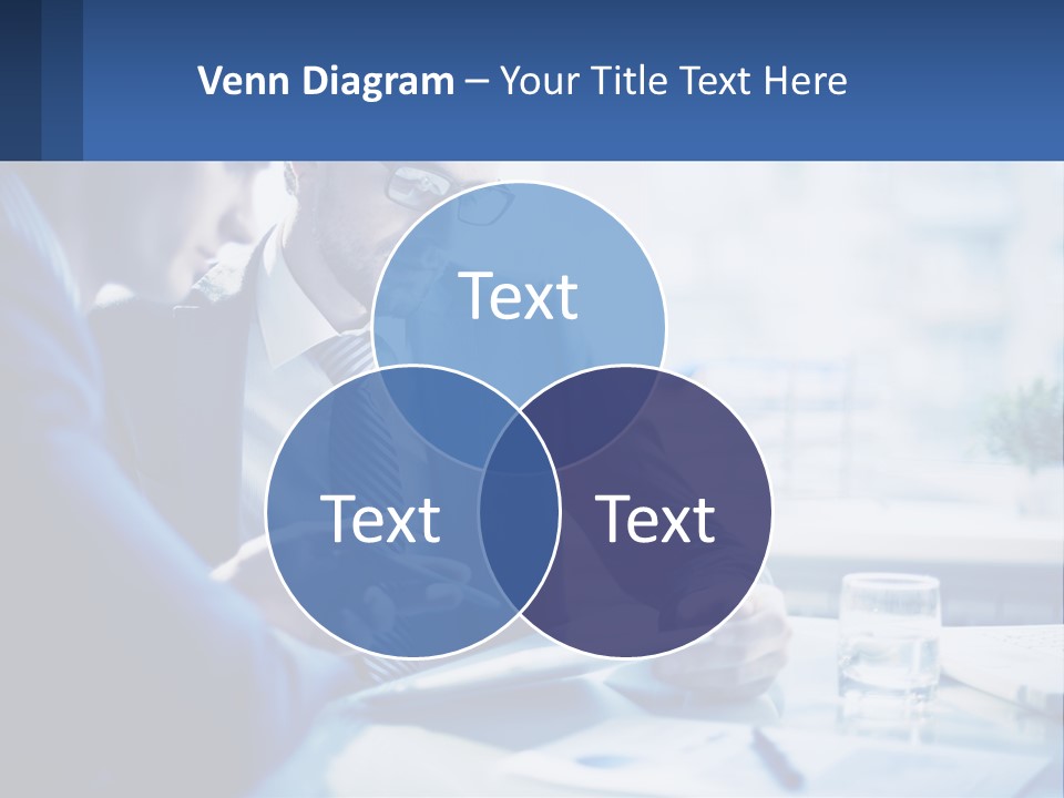Two Men In Business Suits Sitting At A Table Looking At A Cell Phone PowerPoint Template