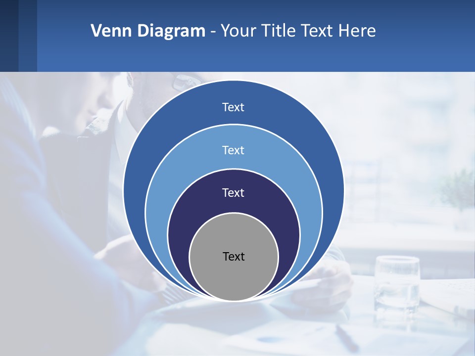 Two Men In Business Suits Sitting At A Table Looking At A Cell Phone PowerPoint Template