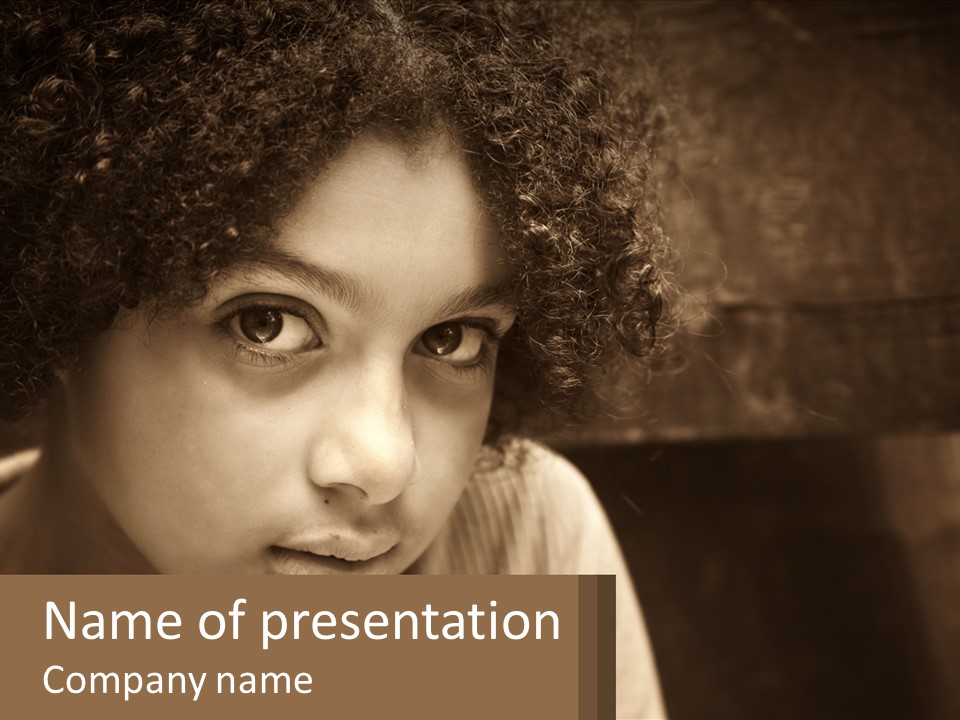A Young Girl With Curly Hair Is Looking At The Camera PowerPoint Template