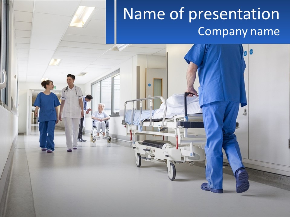 A Group Of Doctors Walking Down A Hospital Hallway PowerPoint Template