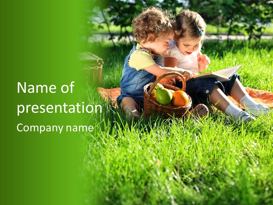 Two Children Reading A Book In The Grass PowerPoint Template