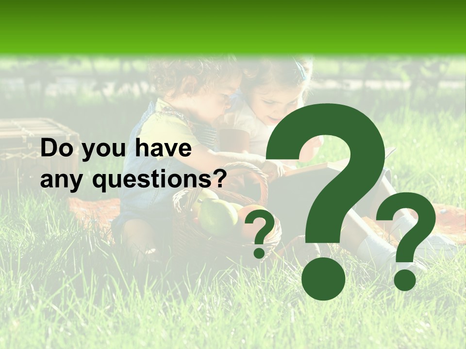 Two Children Reading A Book In The Grass PowerPoint Template