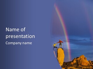 A Man Standing On A Rock With A Rainbow In The Background PowerPoint Template