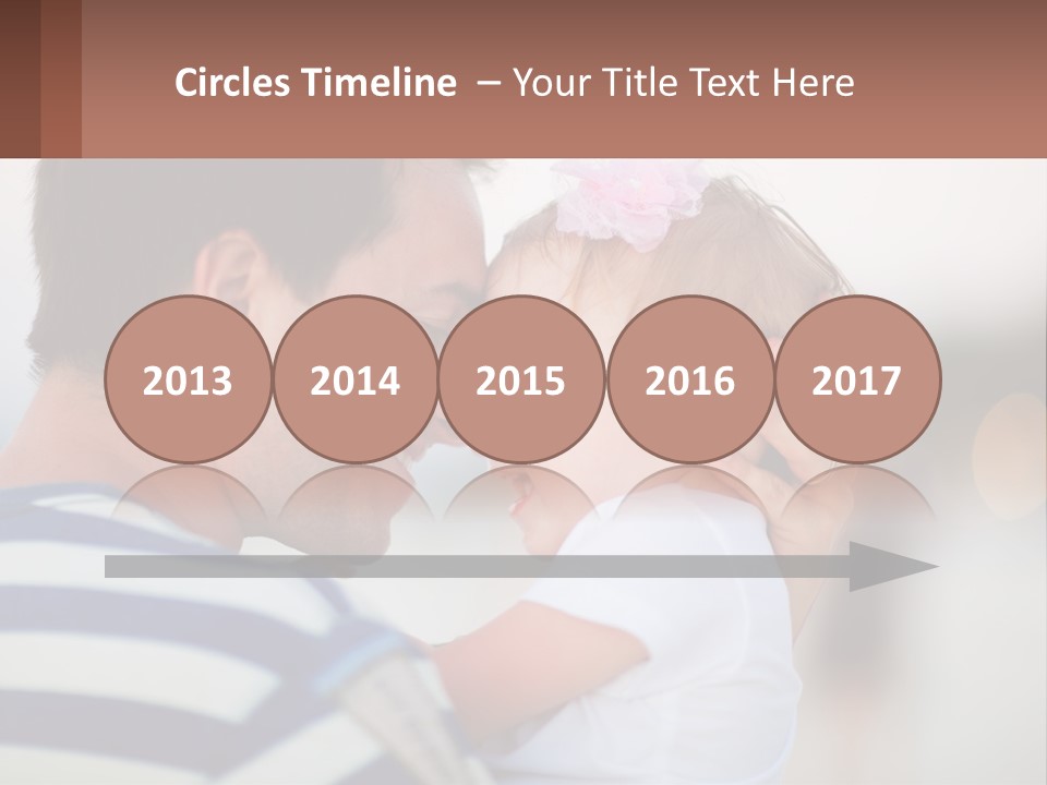 A Man Holding A Baby In His Arms PowerPoint Template